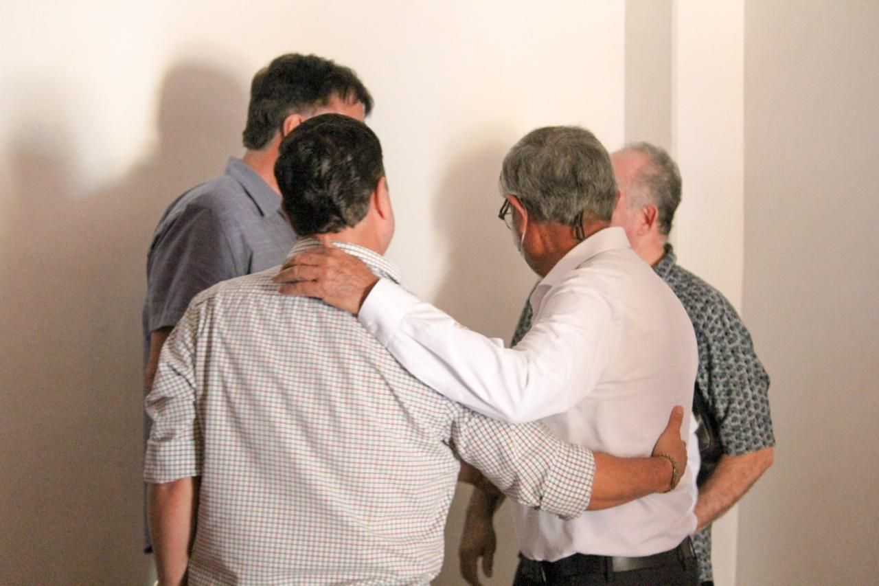 Hombres orando unos por otros